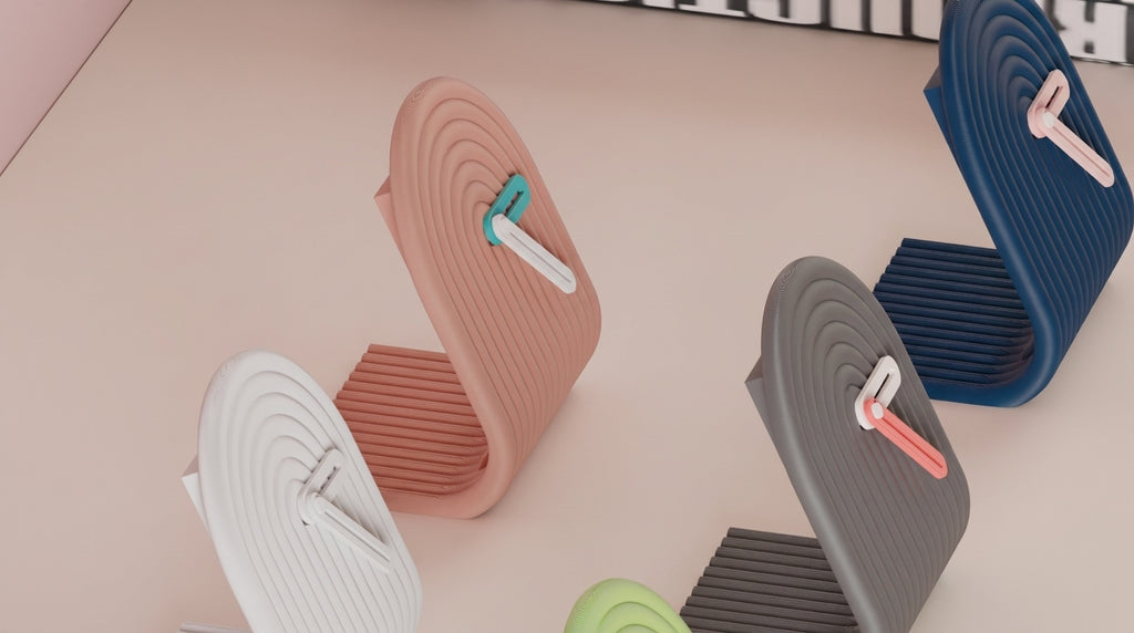 Colorful clocks arranged on a light surface