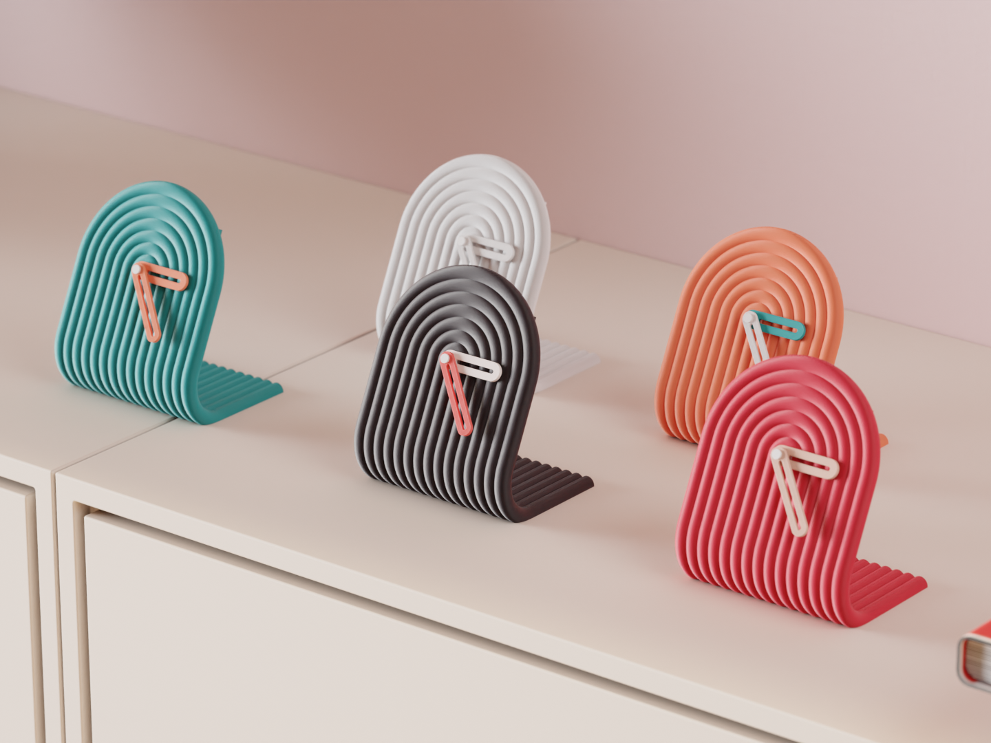 Set of colorful 3D printed clocks on a light surface